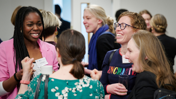 women at conference smiling talking