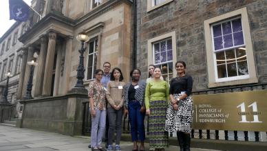 Group of people standing in front of College building