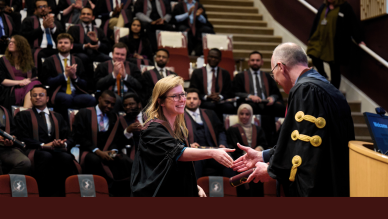 woman handed diploma