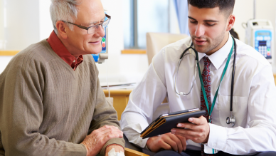 doctor shows older man ipad