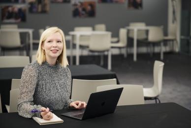 woman on laptop looks up