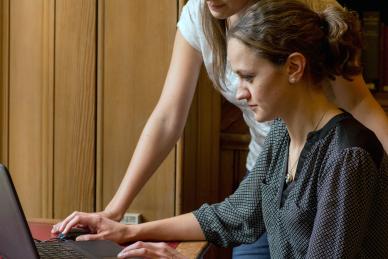 Two people looking at laptop