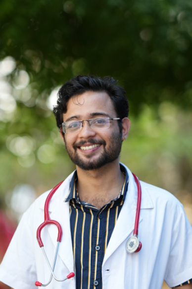 doctor in white coat outside