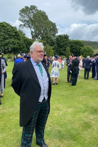 man standing on grass at wedding