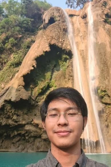 Man in front of waterfall