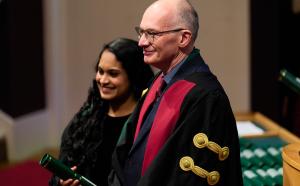 Two people stand for photo