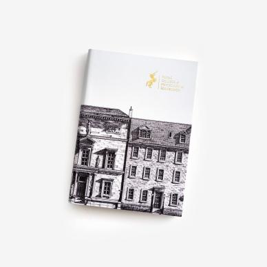 Photo of Recycled B&W leather A5 notebook with gold foil embossed RCPE logo & hand drawn image of College building, Edinburgh.