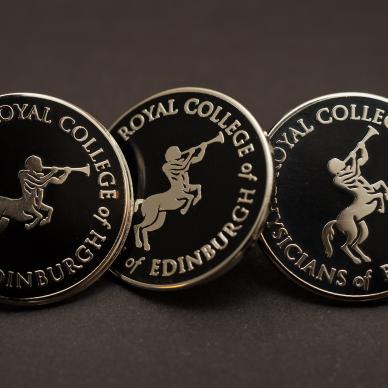 Photo of Black College badge with silver Chiron Emblem