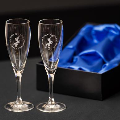 Photo of Pair of glass champagne flutes engraved with Chiron emblem