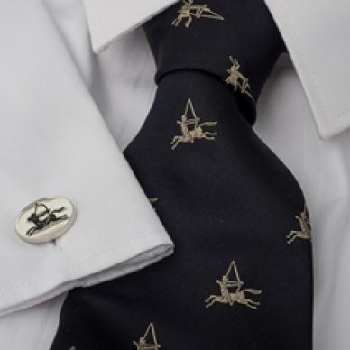 Photo of navy silk tie with gold emblem