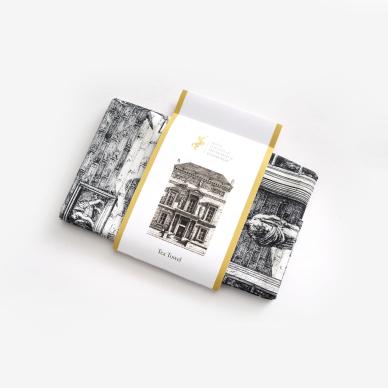 Photo of Tea towel with hand drawn image of RCPE building, 9 Queen Street, packaged in illustrated sleeve.
