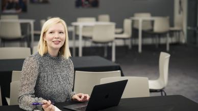 woman on laptop looks up