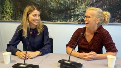 women laughing with speakers