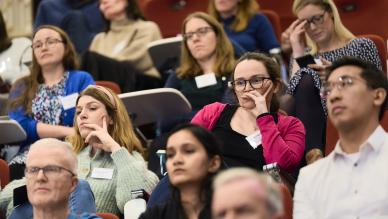 group of people sitting listening to talk